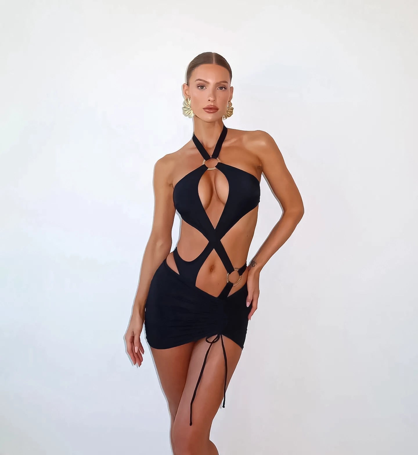 Halter swimsuit, Gold swimsuit, O-ring swimsuit, Cut-out swimsuit, Ruched swimsuit, Swimwear fashion, Beachwear style, Women's swimwear, Trendy swimsuit, Summer fashion.